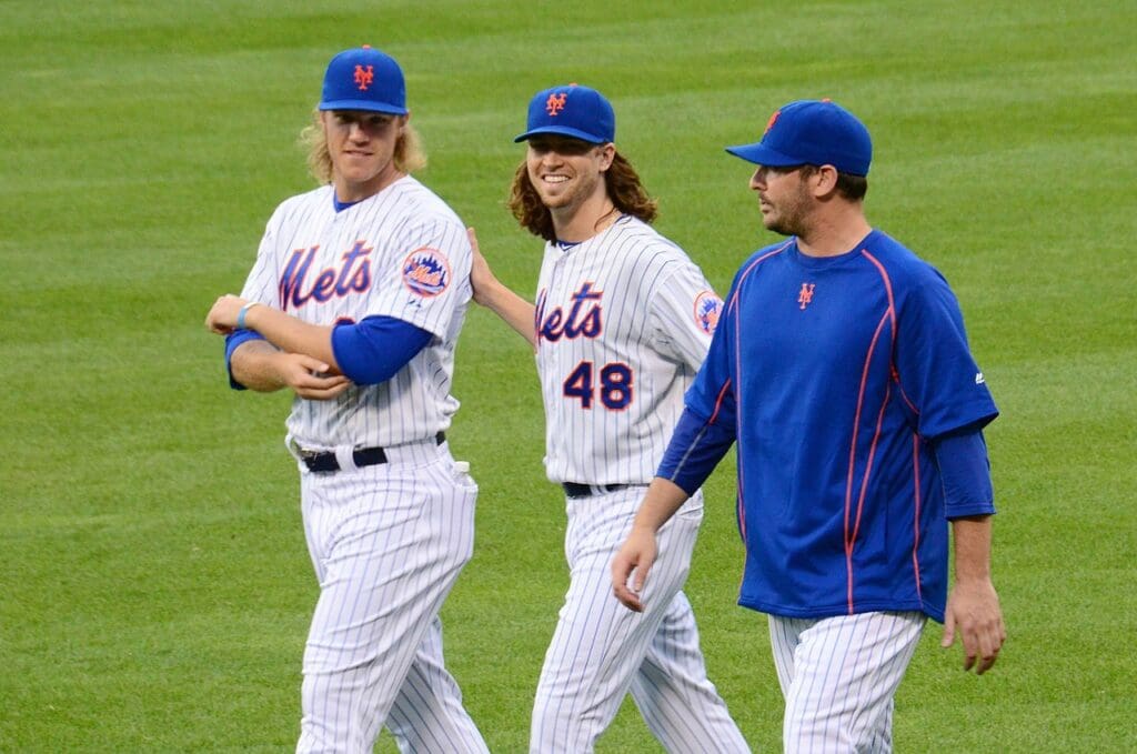 Harvey (right) with Noah Syndergaard (left) and Jacob deGrom (center)