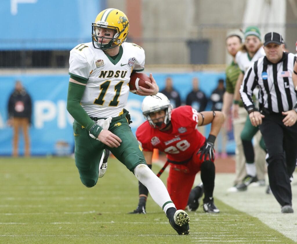Jan 10, 2015; Frisco, TX, USA; North Dakota State Bison quarterback Carson Wentz (11) runs the ball against the Illinois State Redbirds in the first quarter of the Division I championship at Pizza Hut Park.