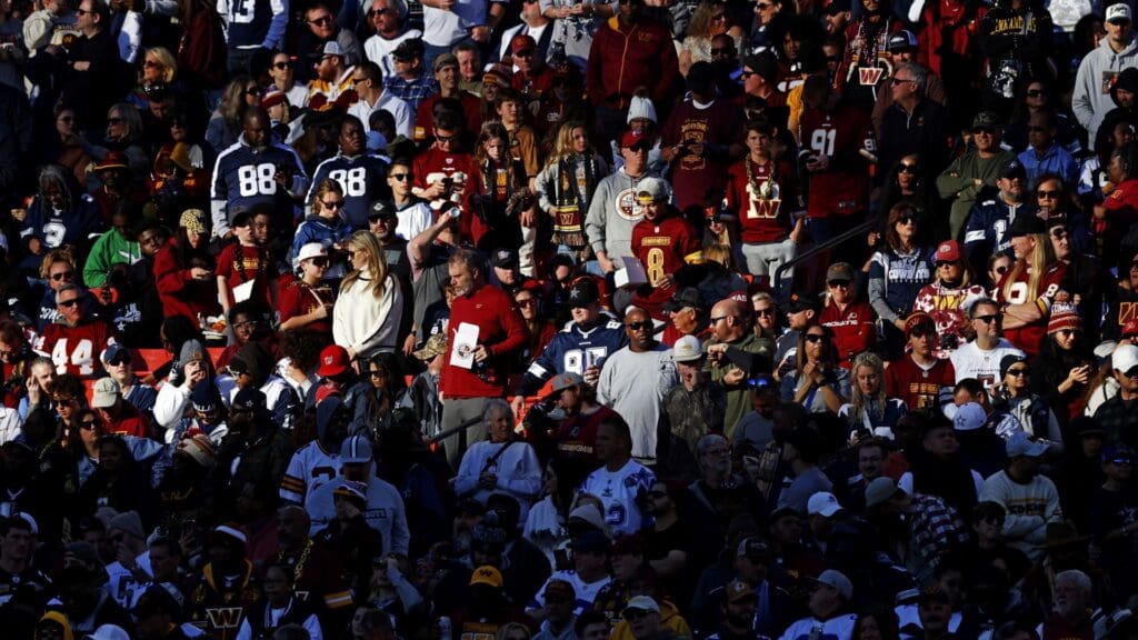 Nov 24, 2024; Landover, Maryland, USA; Fans watch the game between the Washington Commanders and the Dallas Cowboys in the stand during the fourth quarter at Northwest Stadium. Mandatory Credit Peter Casey