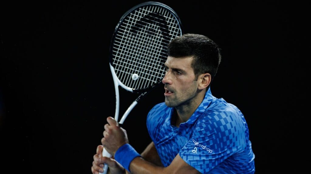 Jan 21, 2023; Melbourne, Victoria, Australia; Novak Djokovic of Serbia hits a backhand against Grigor Dimitrov of Bulgaria on day six of the 2023 Australian Open tennis tournament at Melbourne Park.
