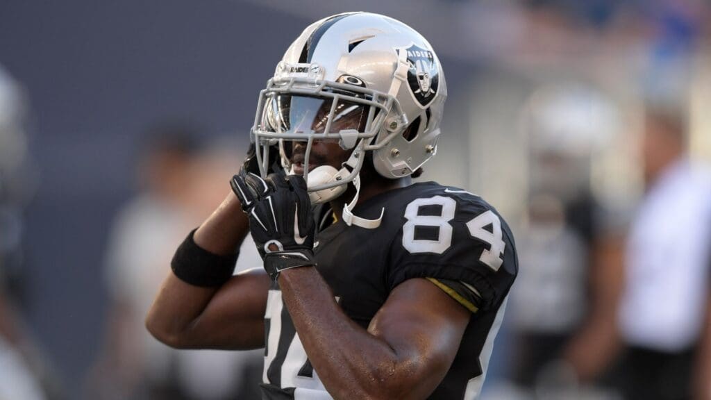 Aug 22, 2019; Winnipeg, Manitoba, CAN; Oakland Raiders wide receiver Antonio Brown (84) adjusts his helmet before a game against the Green Bay Packers at Investors Group Field.