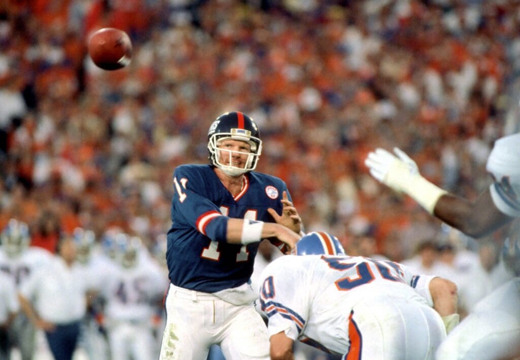 Jan 25,1987; Pasadena, CA, USA; FILE PHOTO; New York Giants quarterback #11 Phil Simms in action against the Denver Broncos during Super Bowl XXI at the Rose Bowl. Simms was named the games most valuable player passing 22-25 attempts for 268 yards and three touchdowns. The Giants defeated the Broncos winning their first Super bowl 39-20.