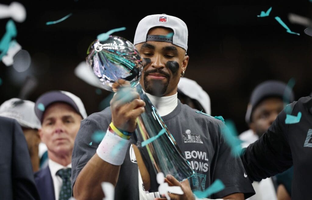 Feb 9, 2025; New Orleans, LA, USA; Philadelphia Eagles quarterback Jalen Hurts holds the Lombardi Trophy during the championship trophy presentation after the Eagles' game against the Kansas City Chiefs in Super Bowl LIX at Caesars Superdome. 