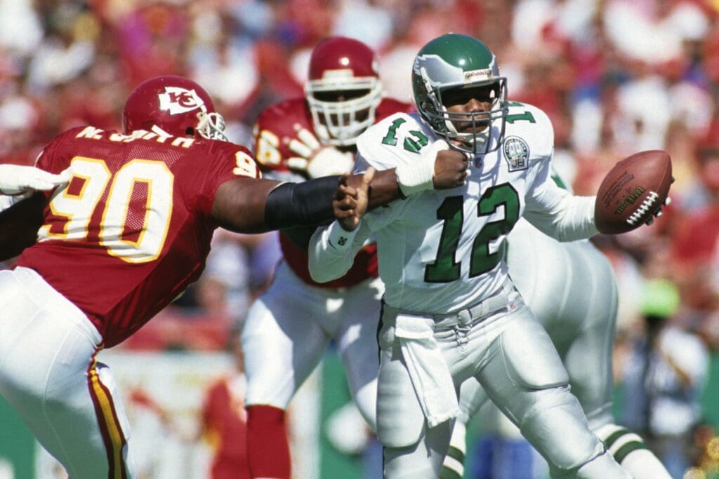Oct 11, 1992; Kansas City, MO, USA; FILE PHOTO; Philadelphia Eagles quarterback Randall Cunningham (12) in action against Kansas City Chiefs defensive end Neil Smith (90) at Arrowhead Stadium.