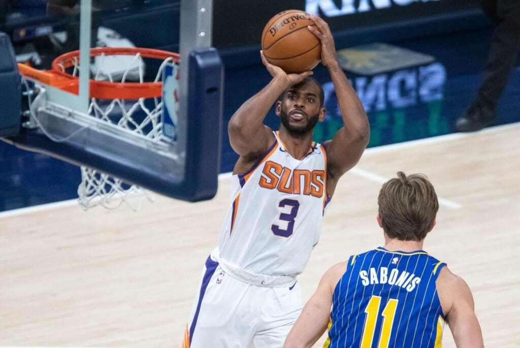 Jan 9, 2021; Indianapolis, Indiana, USA; Phoenix Suns guard Chris Paul (3) shoots the ball over Indiana Pacers forward Domantas Sabonis (11) in the second quarter at Bankers Life Fieldhouse.