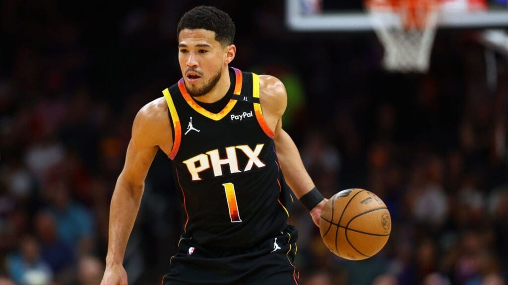 Apr 9, 2025; Phoenix, Arizona, USA; Phoenix Suns guard Devin Booker (1) dribbles the ball against the Oklahoma City Thunder during the first half at Footprint Center