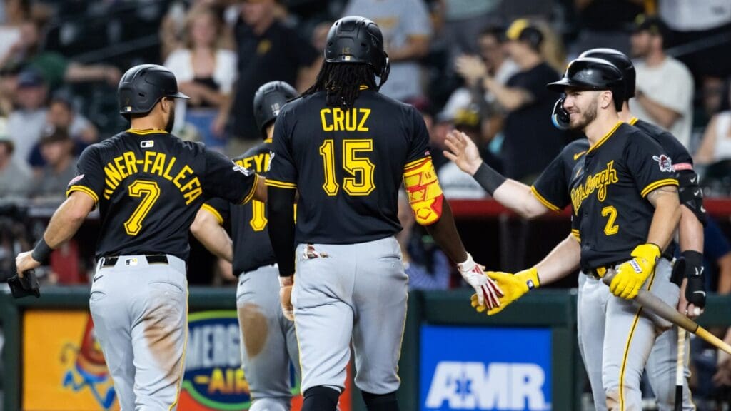 May 27, 2025; Phoenix, Arizona, USA; Pittsburgh Pirates shortstop Isiah Kiner-Falefa (7), outfielder Oneil Cruz (15) and first baseman Spencer Horwitz (2) celebrate the three run home run by Bryan Reynolds in the eighth inning against the Arizona Diamondbacks at Chase Field.