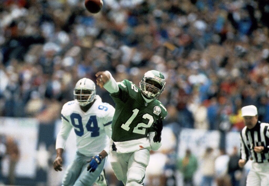 Jan 10, 1993; Dallas, TX, USA; Philadelphia Eagles quarterback Randall Cunningham (12) as he is being chased by Dallas Cowboys defensive end Charles Haley (94) during the 1992 NFC Divisional Playoff Game at Texas Stadium. FILE PHOTO; Mandatory Credit: USA TODAY Sports