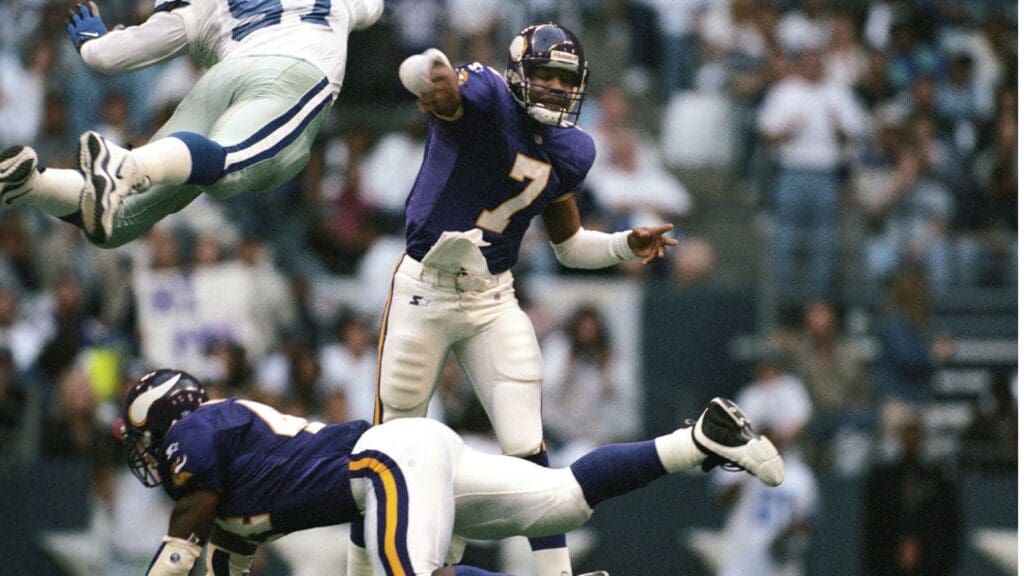 Nov 26, 1998; Irving, TX, USA; FILE PHOTO; Minnesota Vikings quarterback Randall Cunningham (7) is pressured as he releases the ball by Dallas Cowboys defensive end Kavita Pittman (97) during the 1998 season at Texas Stadium.