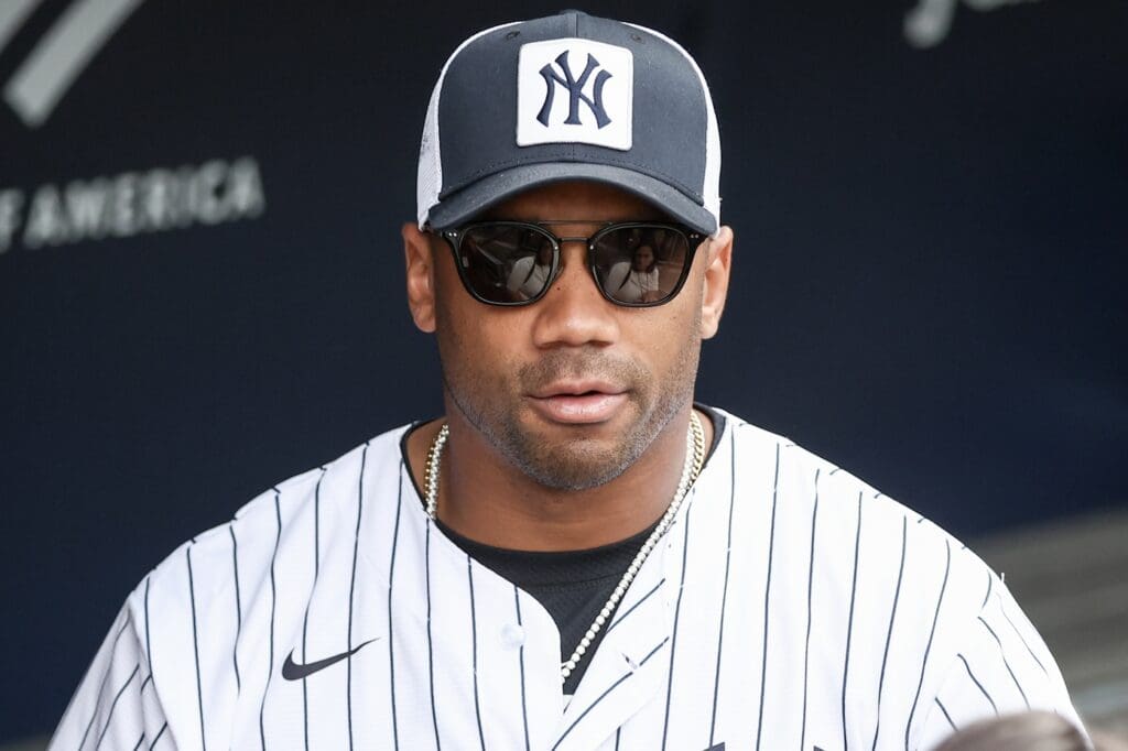 May 18, 2025; Bronx, New York, USA; New York Giants quarterback Russell Wilson watches batting practice prior to the game between the New York Mets and the New York Yankees at Yankee Stadium.