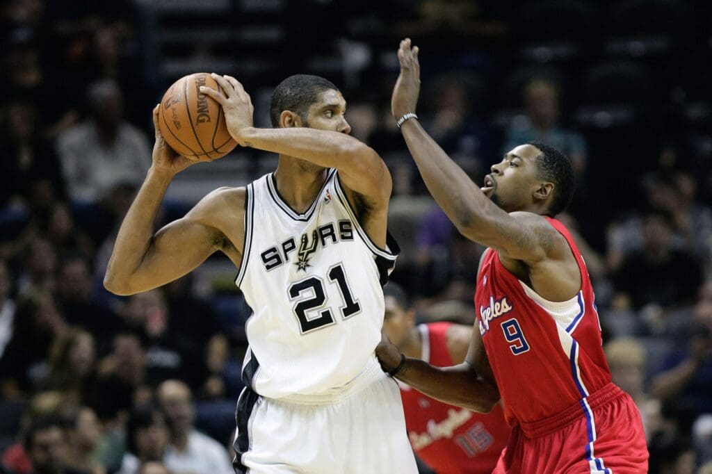 Nov 10, 2010; San Antonio, TX, USA; San Antonio Spurs forward Tim Duncan (21) is defended by Los Angeles Clippers center DeAndre Jordan (9) during the second half at the AT&T Center. The Spurs won 107-95.