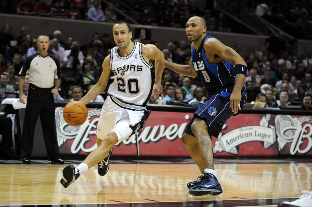 Nov 11, 2009; San Antonio, TX, USA; San Antonio Spurs guard Manu Ginobili (20) dribbles around Dallas Mavericks forward Shawn Marion (0) during the first quarter at the AT&T Center. San Antonio beat Dallas 92-83.