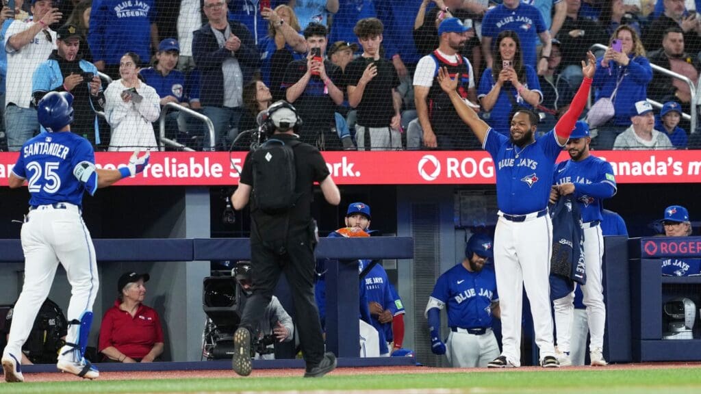 May 20, 2025; Toronto, Ontario, CAN; Toronto Blue Jays designated hitter Anthony Santander (25) hits a two-run home run and celebrates with first baseman Vladimir Guerrero Jr. (27) against the San Diego Padres during the fifth inning at Rogers Centre.