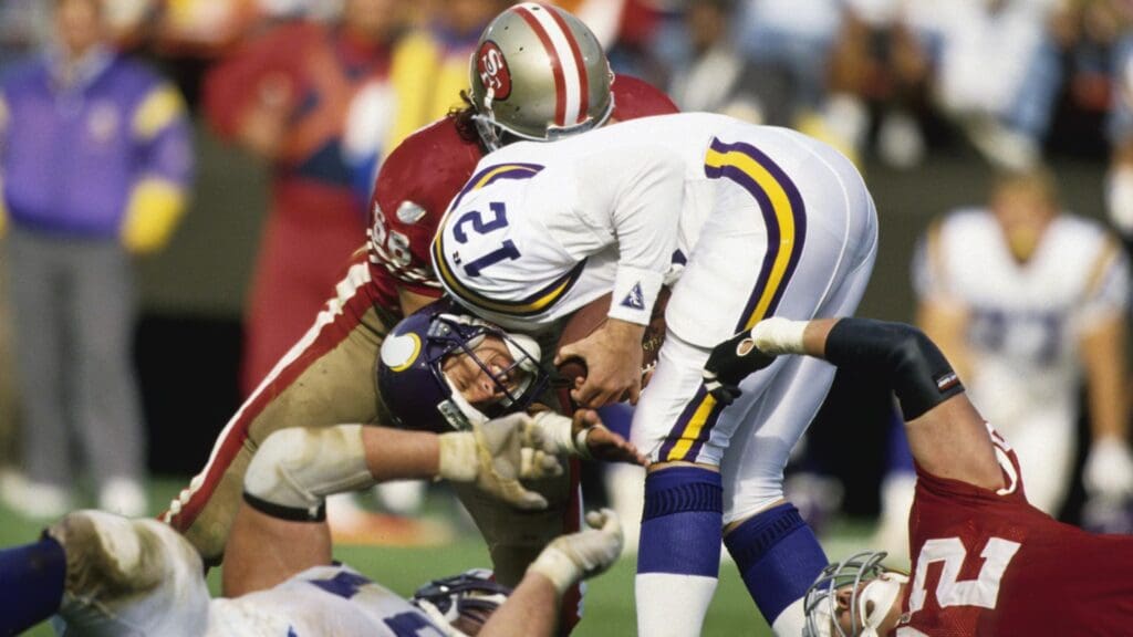 Oct 3, 1993; San Francisco, CA, USA; Minnesota Vikings quarterback Sean Salisbury (12) is tackled by San Francisco 49ers defenders at Candlestick Park. FILE PHOTO;