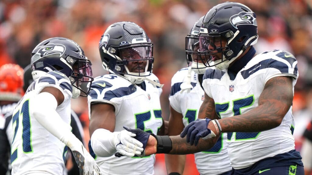 Oct 15, 2023; Cincinnati, Ohio, USA; Seattle Seahawks defensive end Dre'Mont Jones (55) is congratulated by Seattle Seahawks linebacker Boye Mafe (53) and cornerback Devon Witherspoon (21) after a sack in the third quarter at Paycor Stadium.