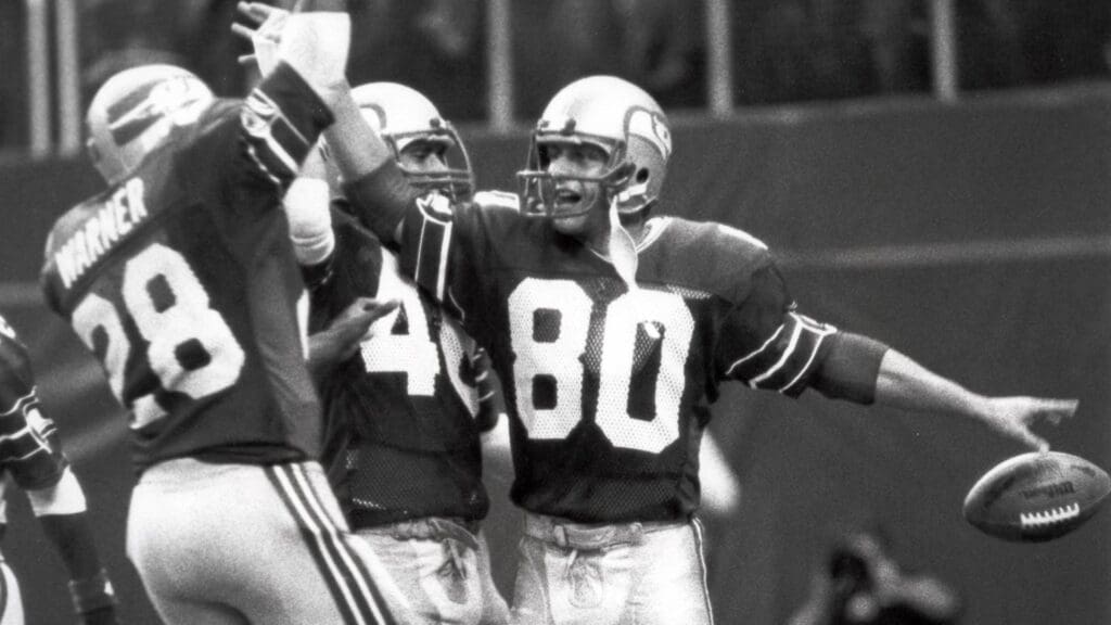 Sep 18, 1983, Seattle, WA, USA; FILE PHOTO; Seattle Seahawks wide receiver Steve Largent (80) celebrates with running back Curt Warner (28) after a 5yd touchdown catch against the San Diego Chargers at the Kingdome. 