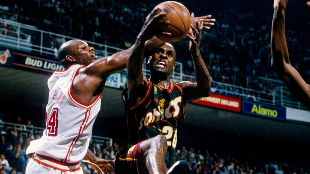 Feb 28, 1997; Miami, FL; USA; FILE PHOTO; Seattle Seattle Supersonics guard Gary Payton (20) attempts a shot against Miami Heat forward Jamal Mashburn (24) at the Miami Arena.