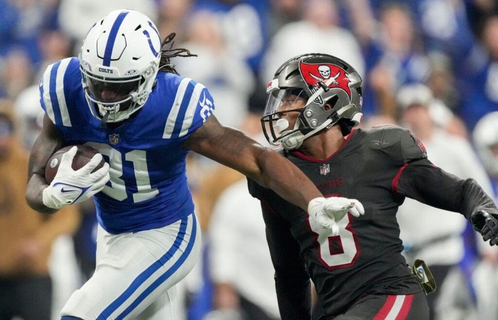 Indianapolis Colts tight end Mo Alie-Cox (81) moves the ball down field as Tampa Bay Buccaneers linebacker SirVocea Dennis (8) gives chase Sunday, Nov. 26, 2023, during a game against the Tampa Bay Buccaneers at Lucas Oil Stadium in Indianapolis.