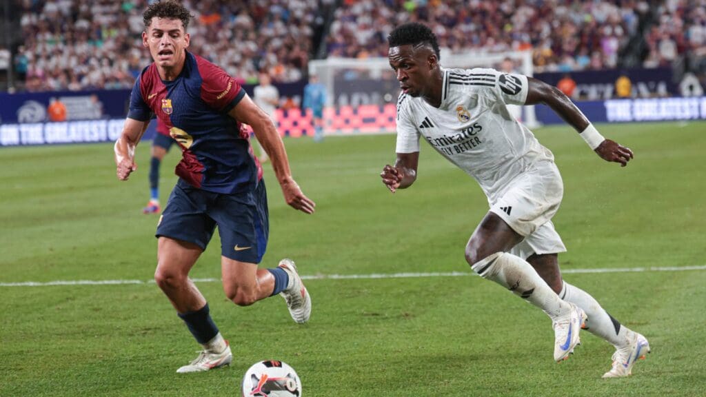 Aug 3, 2024; East Rutherford, NJ, USA; Real Madrid forward Vinicius Junior (7) plays the ball in front of Real Madrid forward Brahim Abdelkader (21) during the second half of an international friendly against Barcelona at MetLife Stadium.