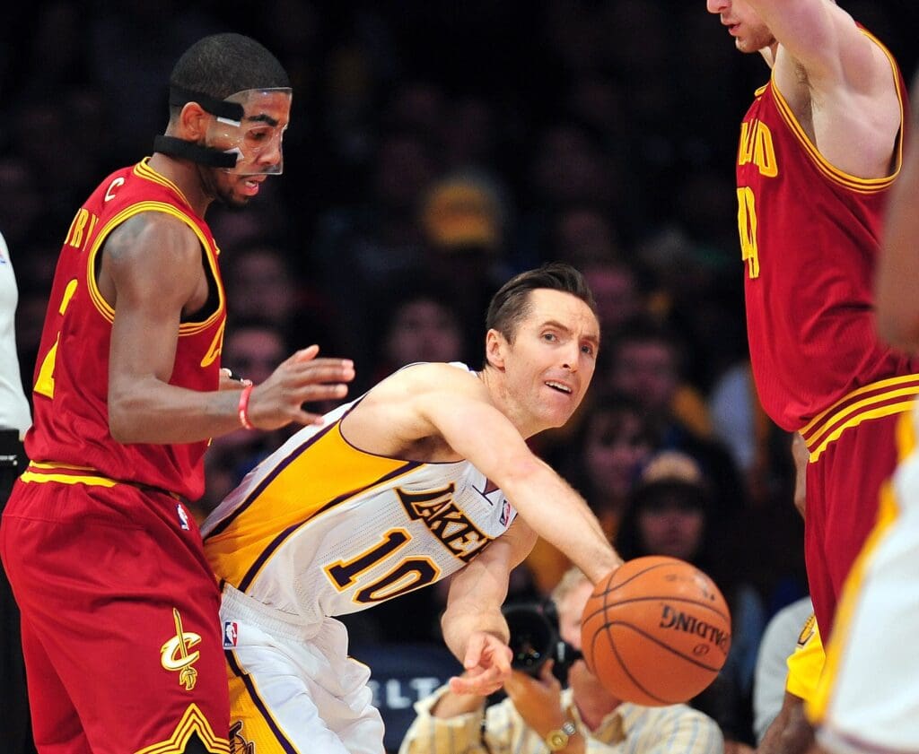 January 13, 2013; Los Angeles, CA, USA; Los Angeles Lakers point guard Steve Nash (10) passes the ball against the Cleveland Cavaliers during the first half at Staples Center. Mandatory Credit: Gary A. Vasquez-USA TODAY Sports