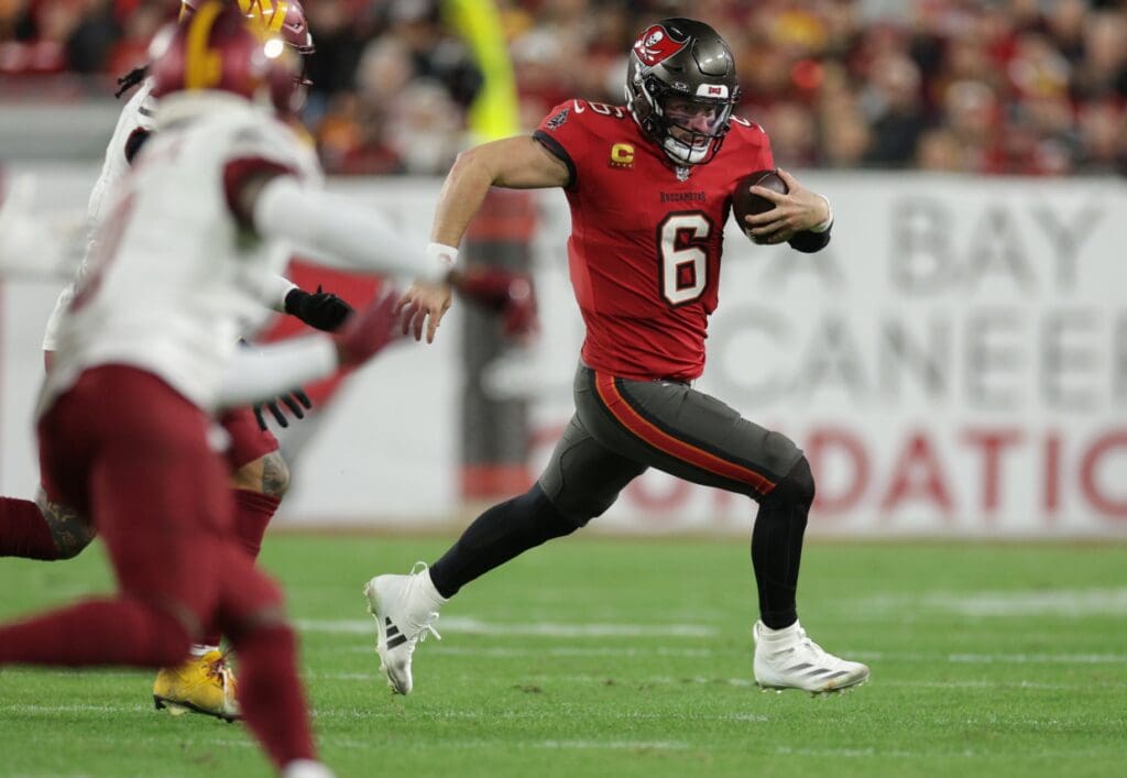 Jan 12, 2025; Tampa, Florida, USA; Tampa Bay Buccaneers quarterback Baker Mayfield (6) scrambles during the fourth quarter of a NFC wild card playoff against the Washington Commanders at Raymond James Stadium