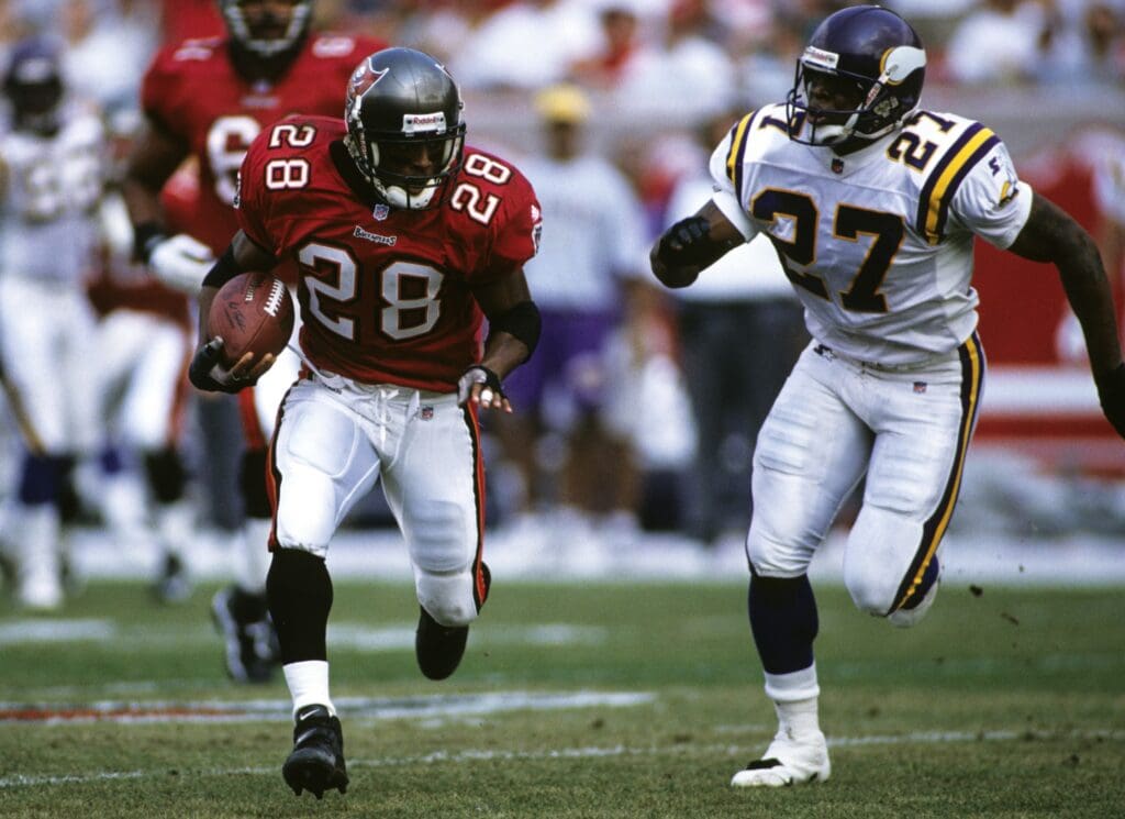 Nov 1, 1998; Tampa, FL, USA; FILE PHOTO; Tampa Bay Buccaneers running back Warrick Dunn (28) in action against Minnesota Vikings defensive back Corey Fuller (28) at Raymond James Stadium.