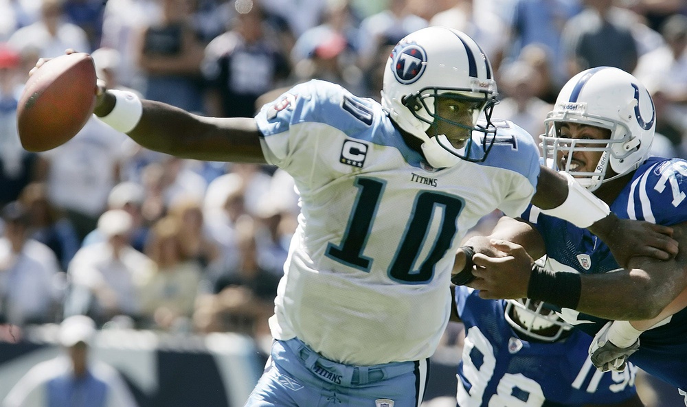 Tennessee Titans quarterback Vince Young (10) scrambles to get away from Indianapolis colts defenders at LP field in Nashville on Sept 16, 2007. The Titans lost their home opener 22-20.