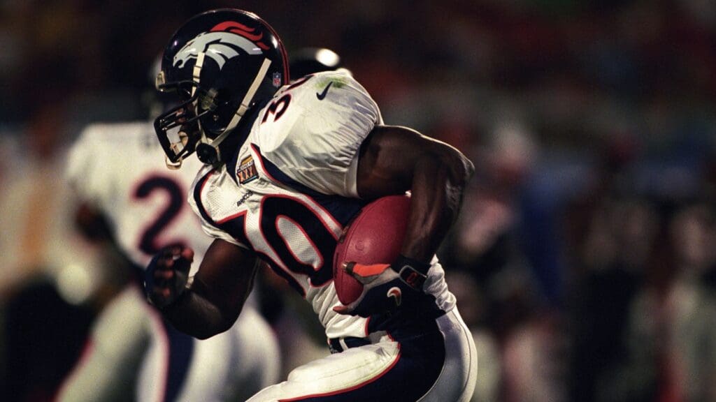 Jan 31, 1999; Miami, FL, USA; FILE PHOTO; Denver Broncos running back Terrell Davis (30) carries the ball against the Atlanta Falcons during Super Bowl XXXIII at Dolphin Stadium. The Broncos defeated the Falcons 34-19.