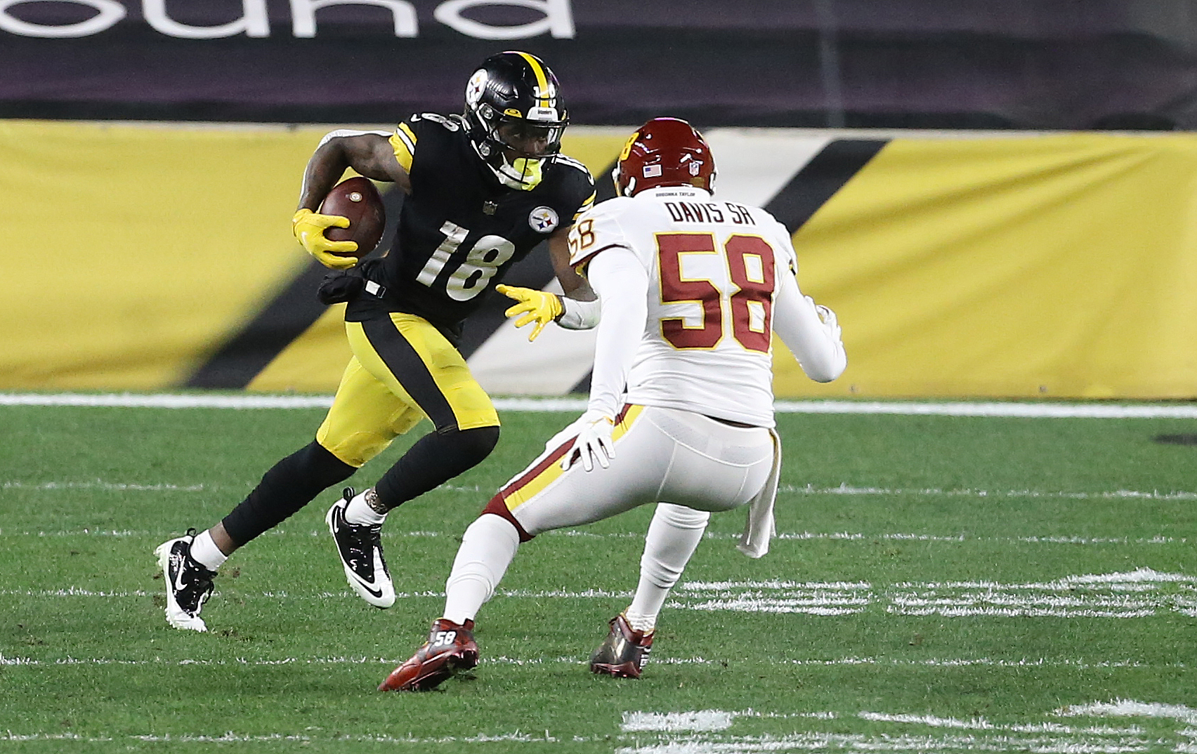 Dec 7, 2020; Pittsburgh, Pennsylvania, USA; Pittsburgh Steelers wide receiver Diontae Johnson (18) runs after a catch as Washington Football Team outside linebacker Thomas Davis (58) defends during the second quarter at Heinz Field. Mandatory Credit: Charles LeClaire-USA TODAY Sports