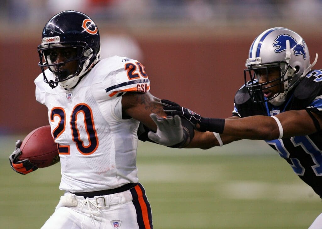 Dec 24, 2006; Detroit, MI, USA; Chicago Bears running back (20) Thomas Jones runs away from Detroit Lions cornerback (31) Stanley Wilson during the 3rd quarter at Ford Field in Detroit, MI. The Bears beat the Lions 26-21.