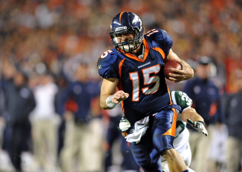 Nov 17, 2011; Denver, CO, USA; Denver Broncos quarterback Tim Tebow (15) runs for a 20 yard touchdown late in the the fourth quarter against New York Jets at Sports Authority Field.