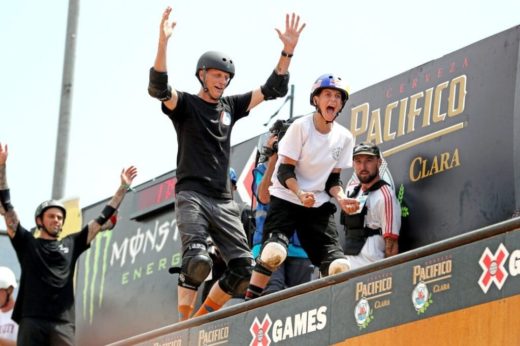 Skateboarding legend and competitor Tony Hawk, left, reacts to what became the gold medal winning trick by Gui Khury, 14, of Brazil during the Skateboard Vert Best Trick at X Games 2023 in Ventura.