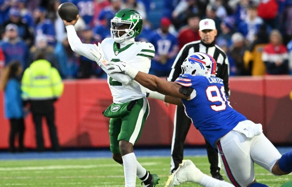 Dec 29, 2024; Orchard Park, New York, USA; New York Jets quarterback Tyrod Taylor (2) is pressured by Buffalo Bills defensive tackle DeWayne Carter (90) during a pass in the fourth quarter at Highmark Stadium.