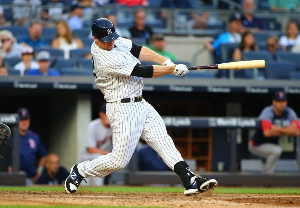 Aug 12, 2017; Bronx, NY, USA; New York Yankees first baseman Chase Headley (12) hits a solo home run against the Boston Red Sox during the ninth inning at Yankee Stadium