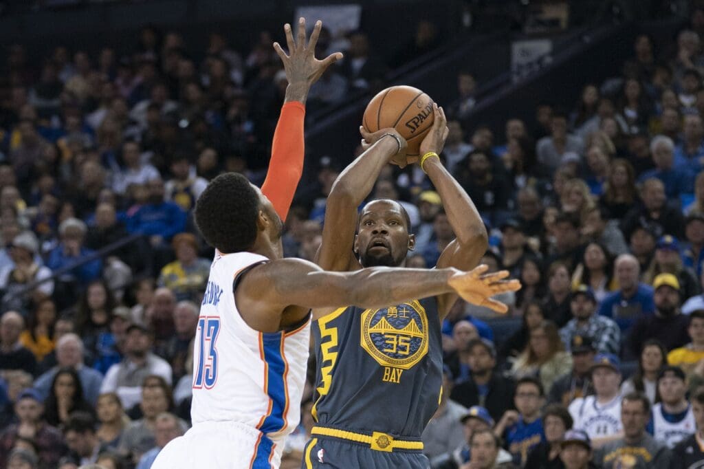 November 21, 2018; Oakland, CA, USA; Golden State Warriors forward Kevin Durant (35) shoots the basketball against Oklahoma City Thunder forward Paul George (13) during the third quarter at Oracle Arena