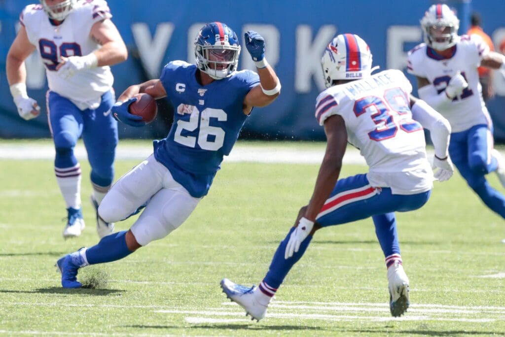Sep 15, 2019; East Rutherford, NJ, USA; New York Giants running back Saquon Barkley (26) carries the ball as Buffalo Bills defensive back Levi Wallace (39) defends during the first half at MetLife Stadium.