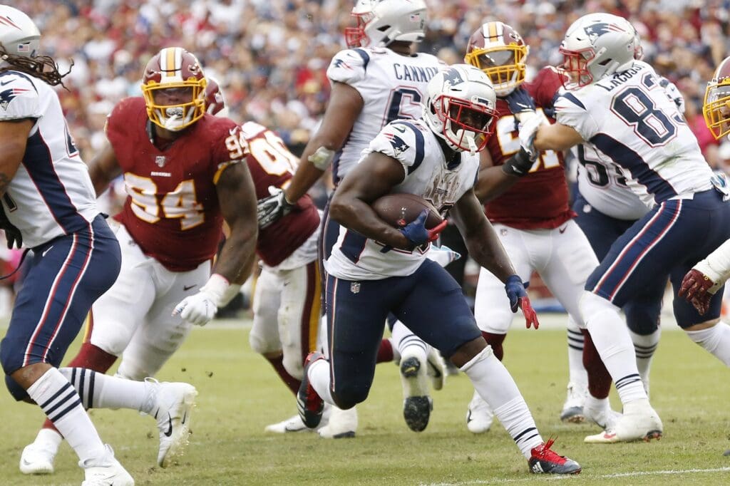 Oct 6, 2019; Landover, MD, USA; New England Patriots running back Sony Michel (26) carries the ball past Washington Redskins nose tackle Daron Payne (94) en route to a touchdown in the third quarter at FedExField.