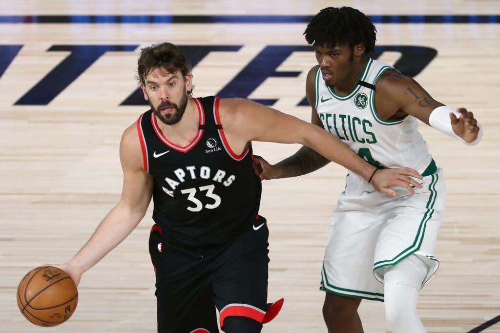 Sep 5, 2020; Lake Buena Vista, Florida, USA; Toronto Raptors center Marc Gasol (33) dribbles the ball against Boston Celtics center Robert Williams III (44) during the first half of game four in the second round of the 2020 NBA Playoffs at ESPN Wide World of Sports Complex. Mandatory Credit: Kim Klement-USA TODAY Sports