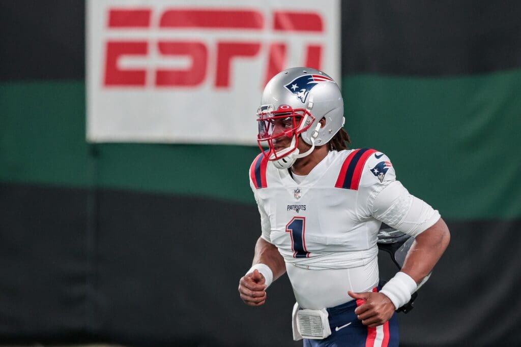 Nov 9, 2020; East Rutherford, New Jersey, USA; New England Patriots quarterback Cam Newton (1) runs on to the field before his game against the New York Jets at MetLife Stadium.