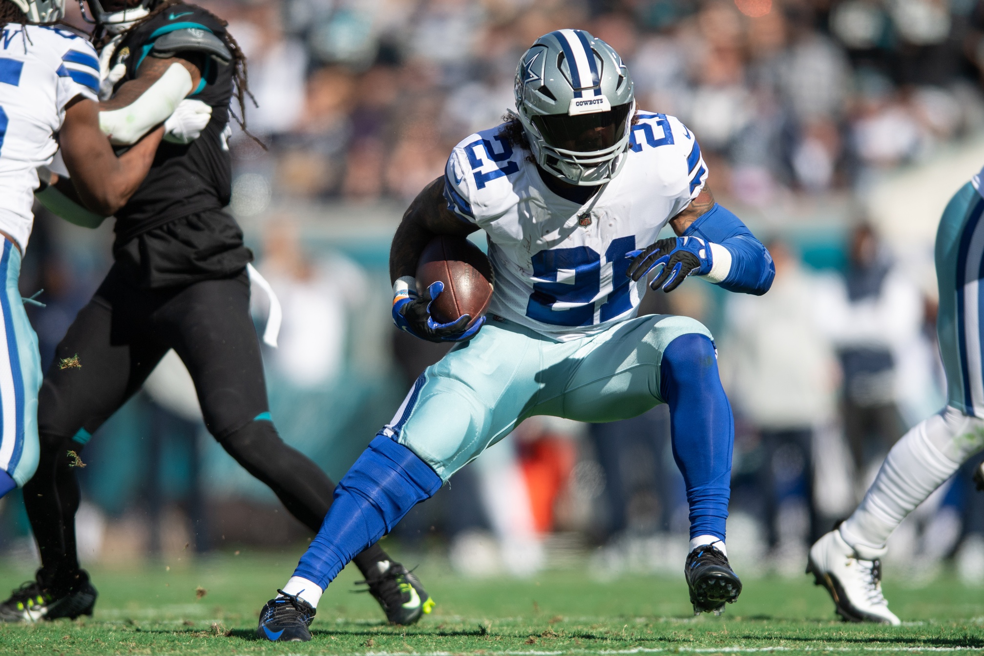 Dec 18, 2022; Jacksonville, Florida, USA; Dallas Cowboys running back Ezekiel Elliot (21) runs the ball against the Jacksonville Jaguars in the first quarter at TIAA Bank Field. Mandatory Credit: Jeremy Reper-USA TODAY Sports
