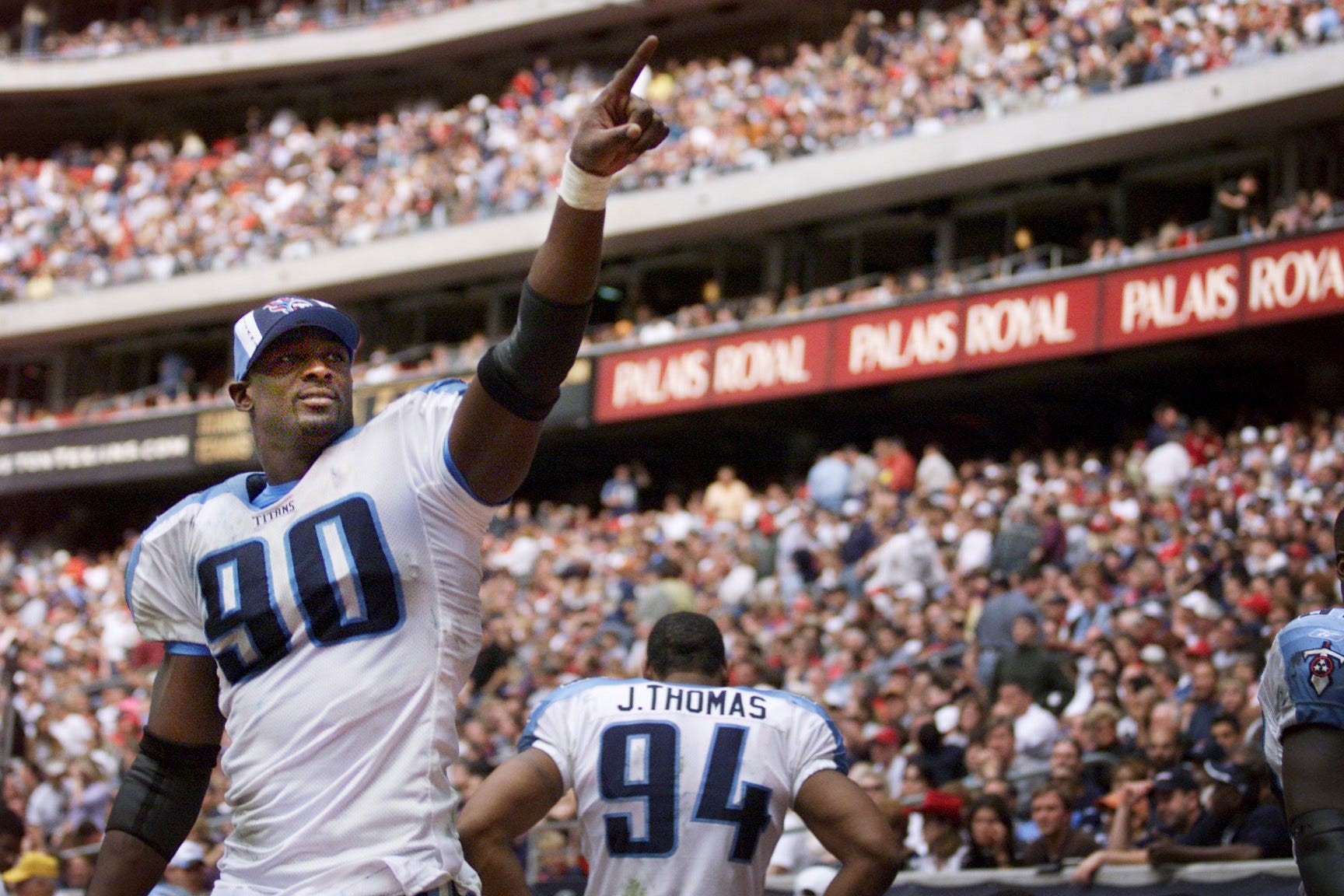 Tennessee Titans defensive end Jevon Kearse (90) acknowledged fans in the stadium moments after teammate Eddie George scored on a touchdown in the fourth quarter to secure a 13-3 victory over the Houston Texans in Houston Dec. 29, 2002. The win in the season final secured the No. 2 AFC seed and a first-round playoff bye. 122902 Titans