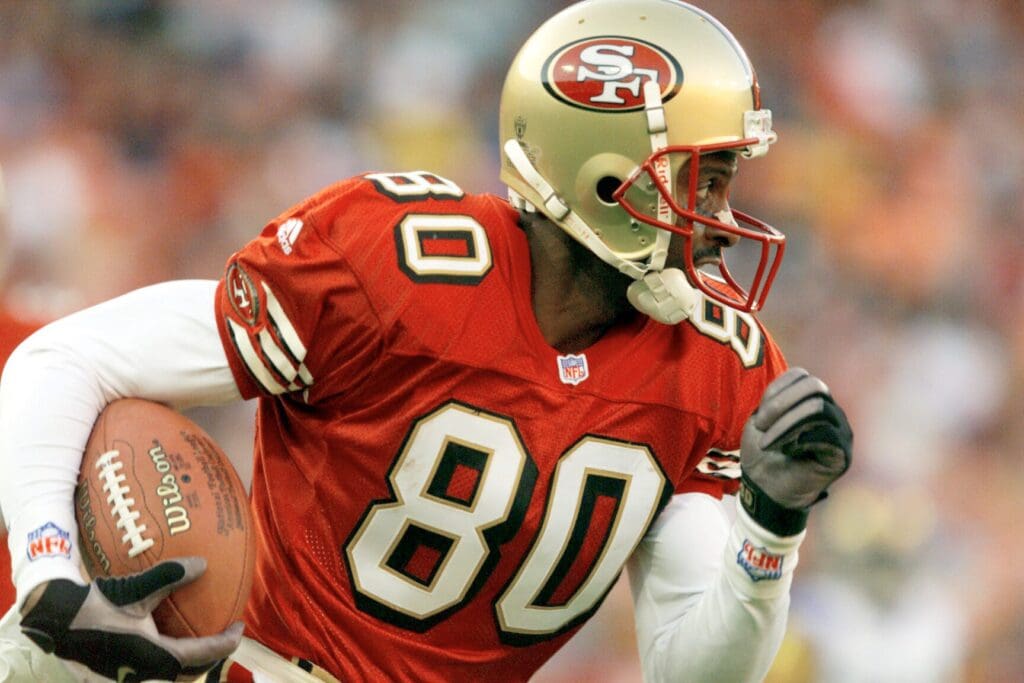 San Francisco receiver Jerry Rice heads up field with a pass during the 4th quarter of the 49ers' loss to the Rams at 3Com Park on Nov. 21,1999