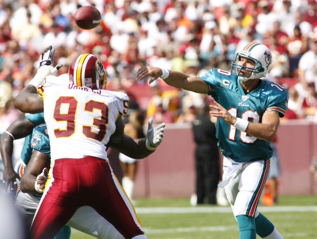 Sept 9, 2007; Landover, MD, USA; Miami Dolphins quarterback Trent Green (10) throws against the defense of Washington Redskins defensive end Phillip Daniels (93) during the Redskins 16-13 overtime victory at FedEx Field in Landover, MD.