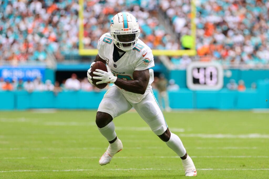 Nov 17, 2024; Miami Gardens, Florida, USA; Miami Dolphins wide receiver Tyreek Hill (10) runs with the football against the Las Vegas Raiders during the first quarter at Hard Rock Stadium. 