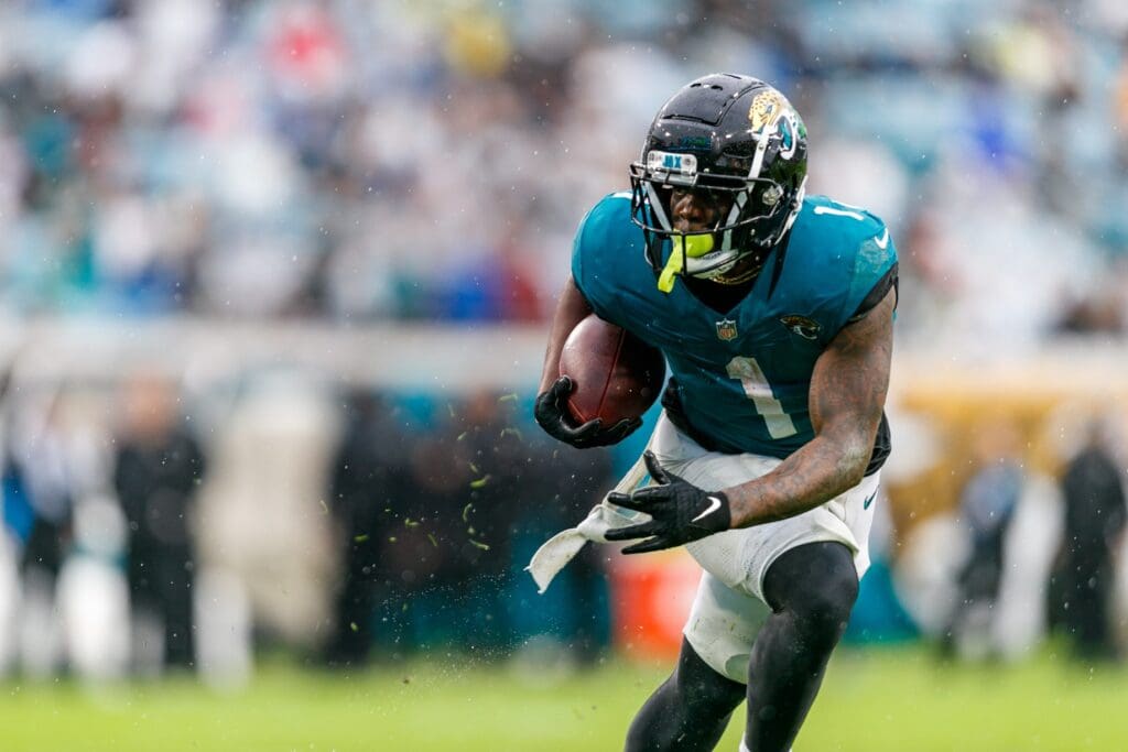 Dec 29, 2024; Jacksonville, Florida, USA; Jacksonville Jaguars running back Travis Etienne Jr. (1) runs the ball against the Tennessee Titans during the second quarter at EverBank Stadium.