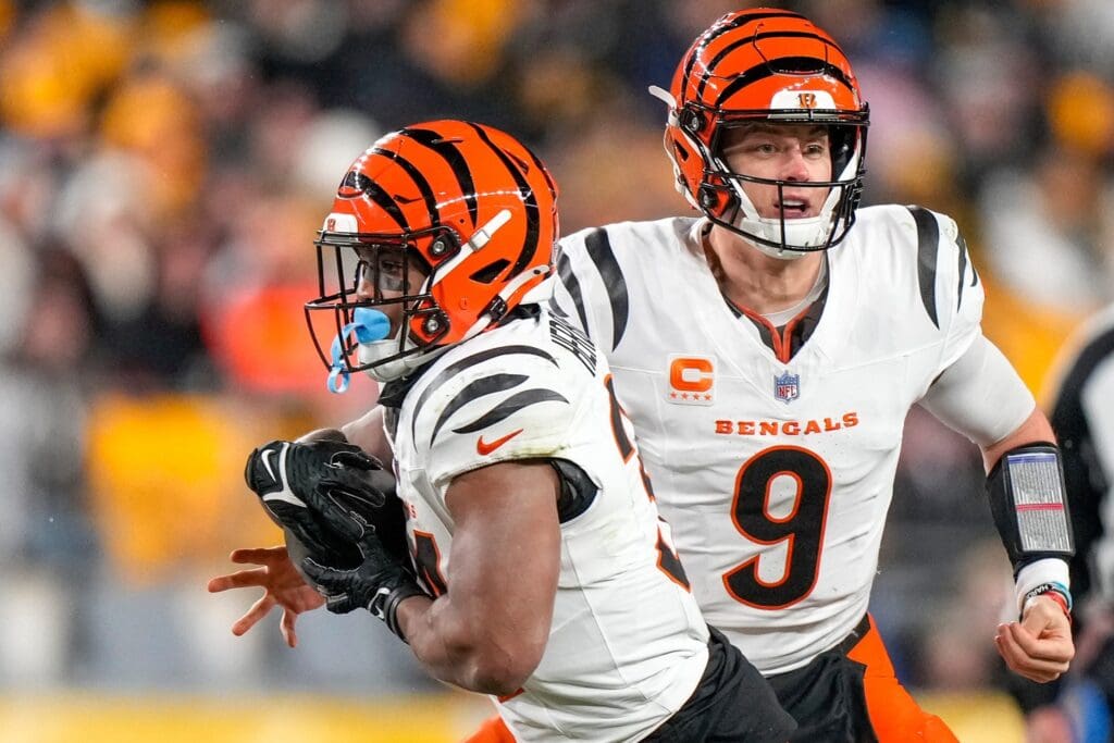 Cincinnati Bengals quarterback Joe Burrow (9) hands off to running back Khalil Herbert (34) in the second quarter of the NFL Week 18 game between the Pittsburgh Steelers and the Cincinnati Bengals at Acrisure Stadium in Pittsburgh on Saturday, Jan. 4, 2025.