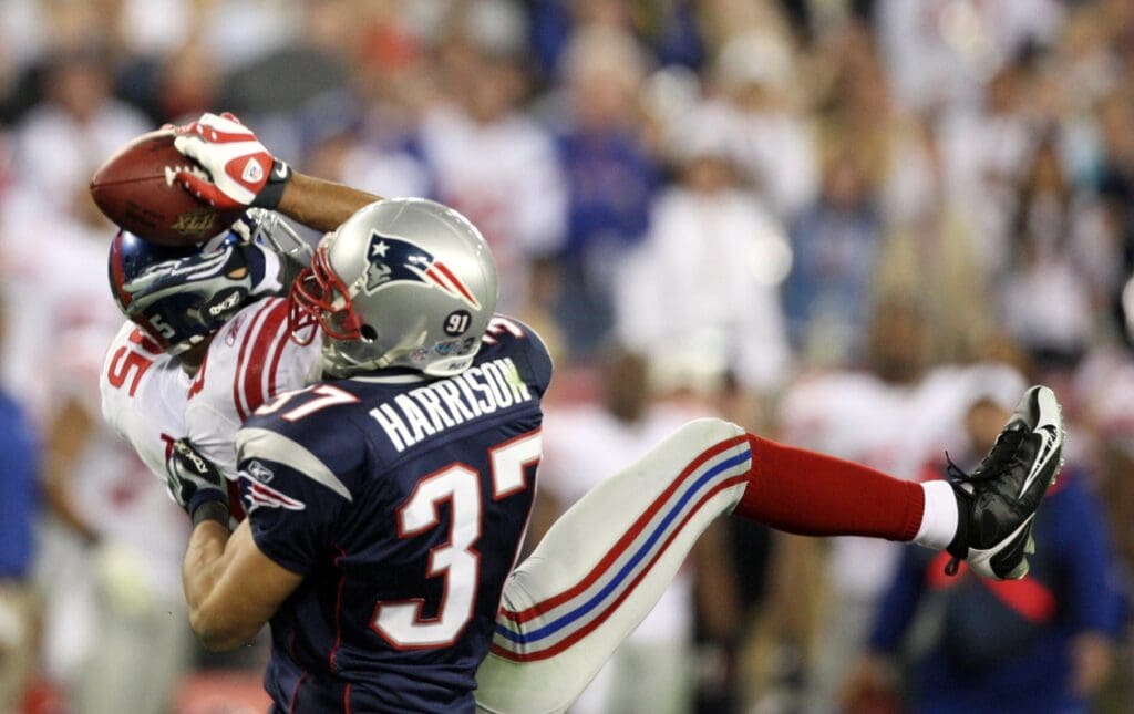 Feb 3, 2008; Glendale, AZ, USA; New York Giants wide receiver David Tyree (85) make the catch over New England Patriots safety Rodney Harrison (37) in the fourth quarter of Super Bowl XLII at the University of Phoenix Stadium. New York Giants defeated the New England Patriots with a final of 17-14.