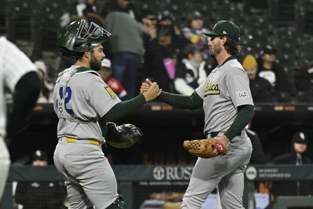 Caption: Apr 15, 2025; Chicago, Illinois, USA; Athletics pitcher Mitch Spence (28) and catcher Shea Langeliers (23) after the game against the Chicago White Sox at Rate Field. “All players wore #42 for Jackie Robinson Day” at Rate Field.