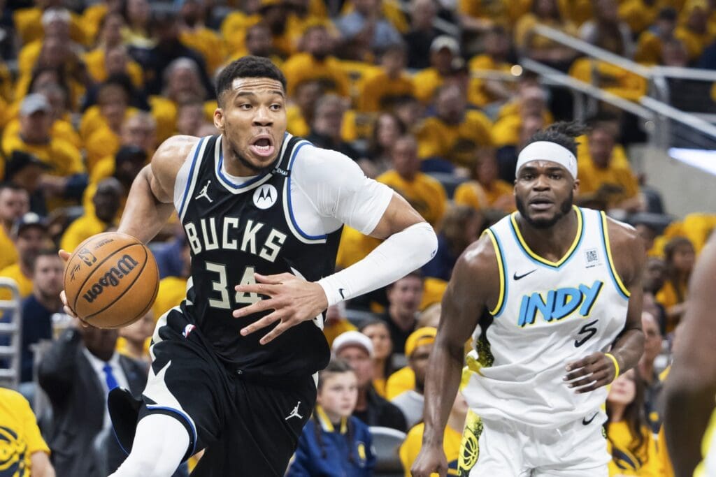Apr 19, 2025; Indianapolis, Indiana, USA; Milwaukee Bucks forward Giannis Antetokounmpo (34) dribbles the ball while Indiana Pacers forward Jarace Walker (5) defends in the first half at Gainbridge Fieldhouse.