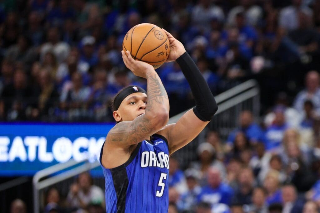 Apr 27, 2025; Orlando, Florida, USA; Orlando Magic forward Paolo Banchero (5) shoots the ball against the Boston Celtics in the third quarter during game four of first round for the 2025 NBA Playoffs at Kia Center